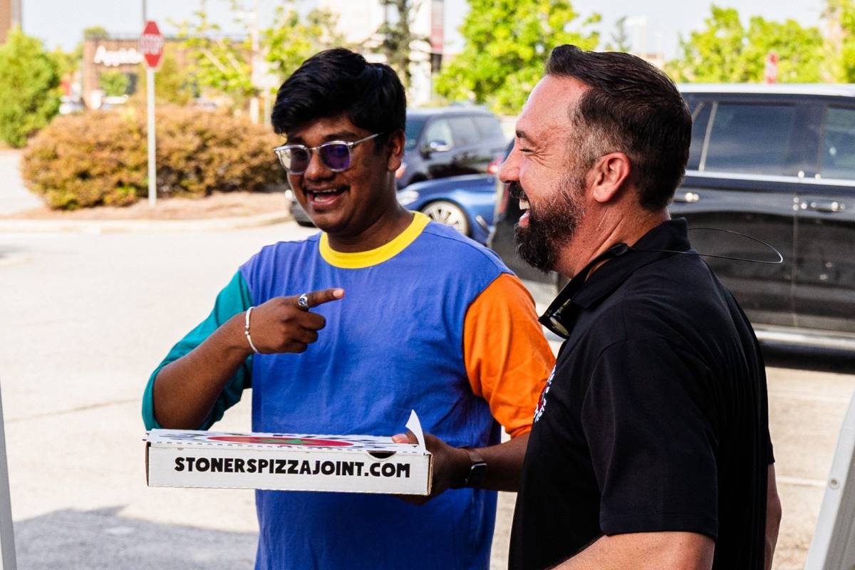 A local business owner greeting a guest